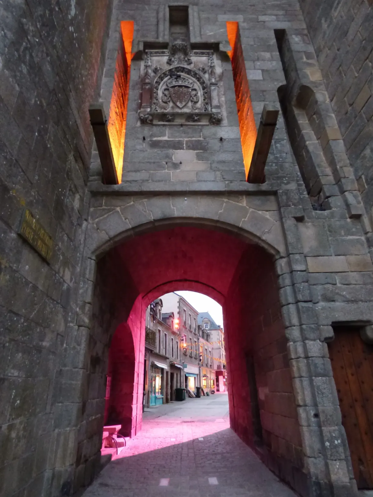 Vaulted passage under the fortified gate, lit in pink