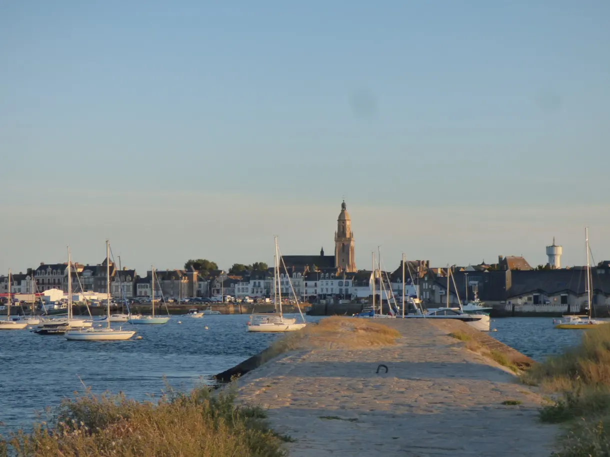 Stone slipway facing the harbour and the bell tower of the town