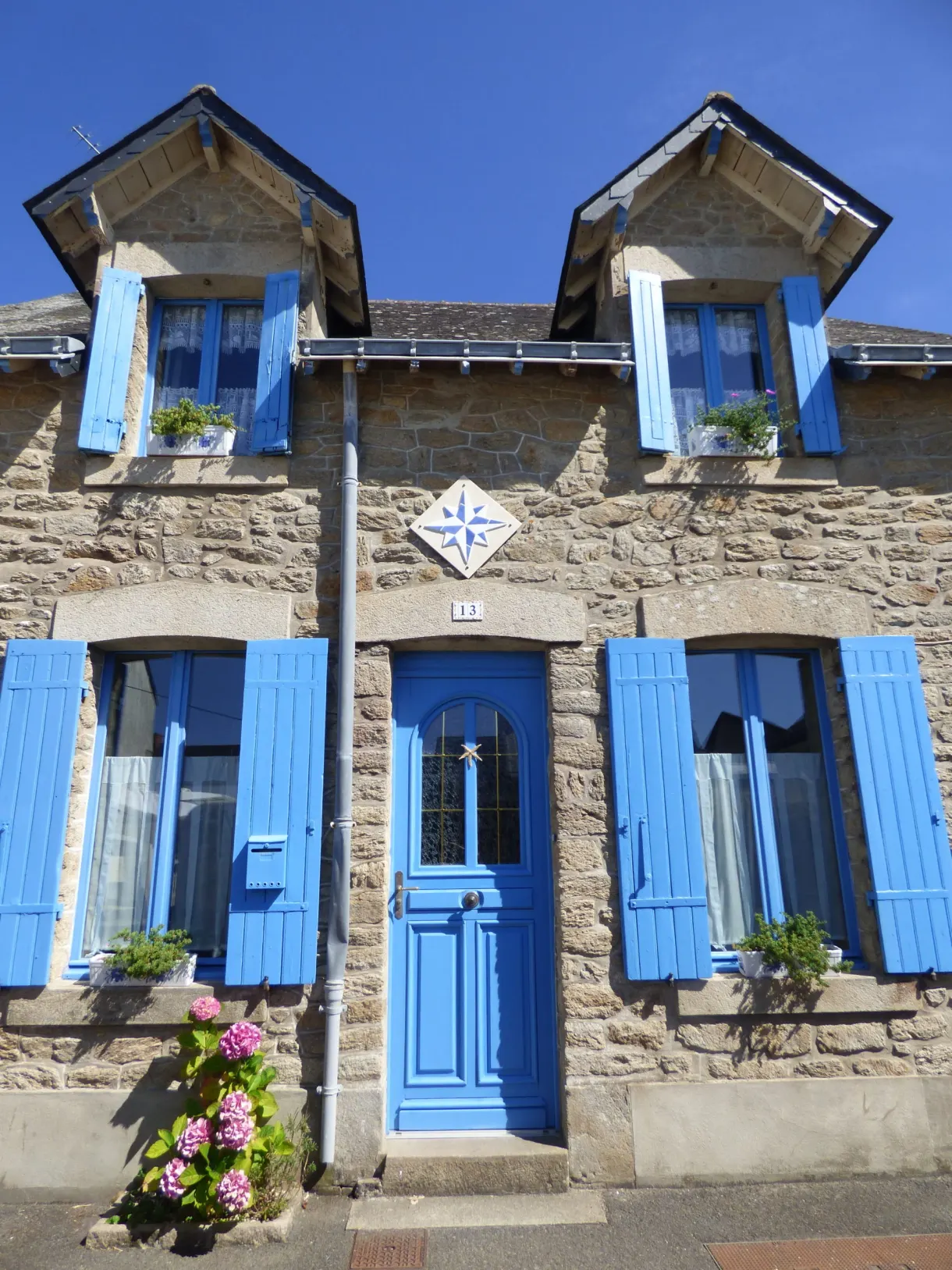 Stone fisherman's house with bright blue shutters