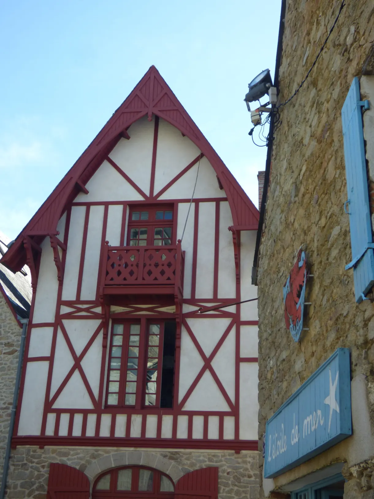 Gable with red half-timbering above a blue sign