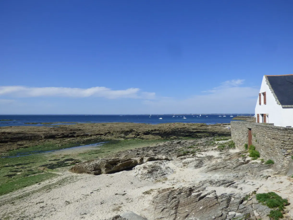 Isolated white house above a rocky foreshore