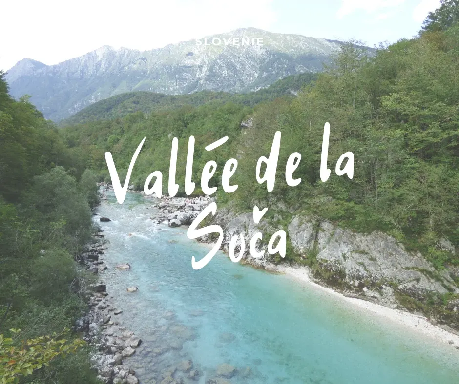 Turquoise river winding between wooded slopes in Slovenia