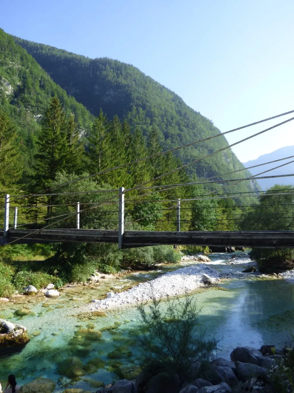 Suspension footbridge above the turquoise water of the canyon
