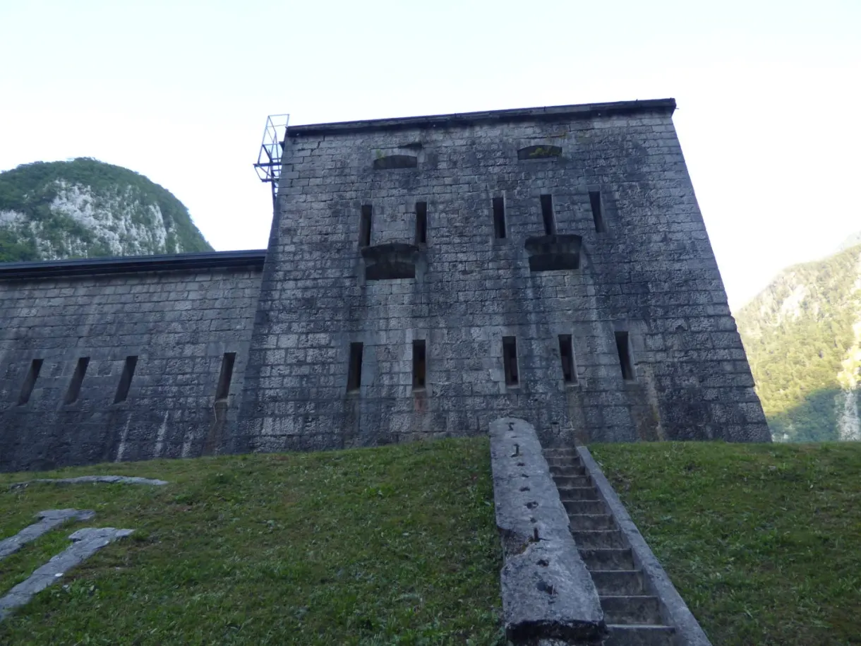 Grey stone fort set against the mountain, access staircase