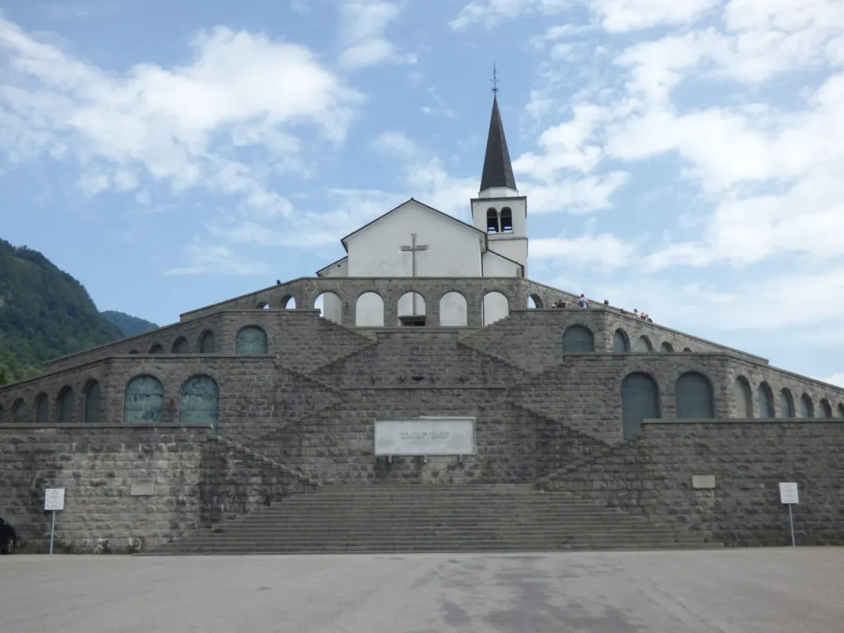 Stepped stone memorial topped with a white bell tower