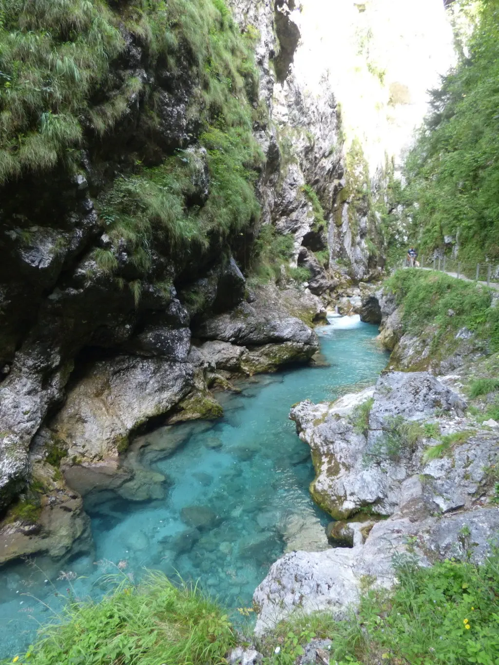 Narrow gorge with grey walls and turquoise water