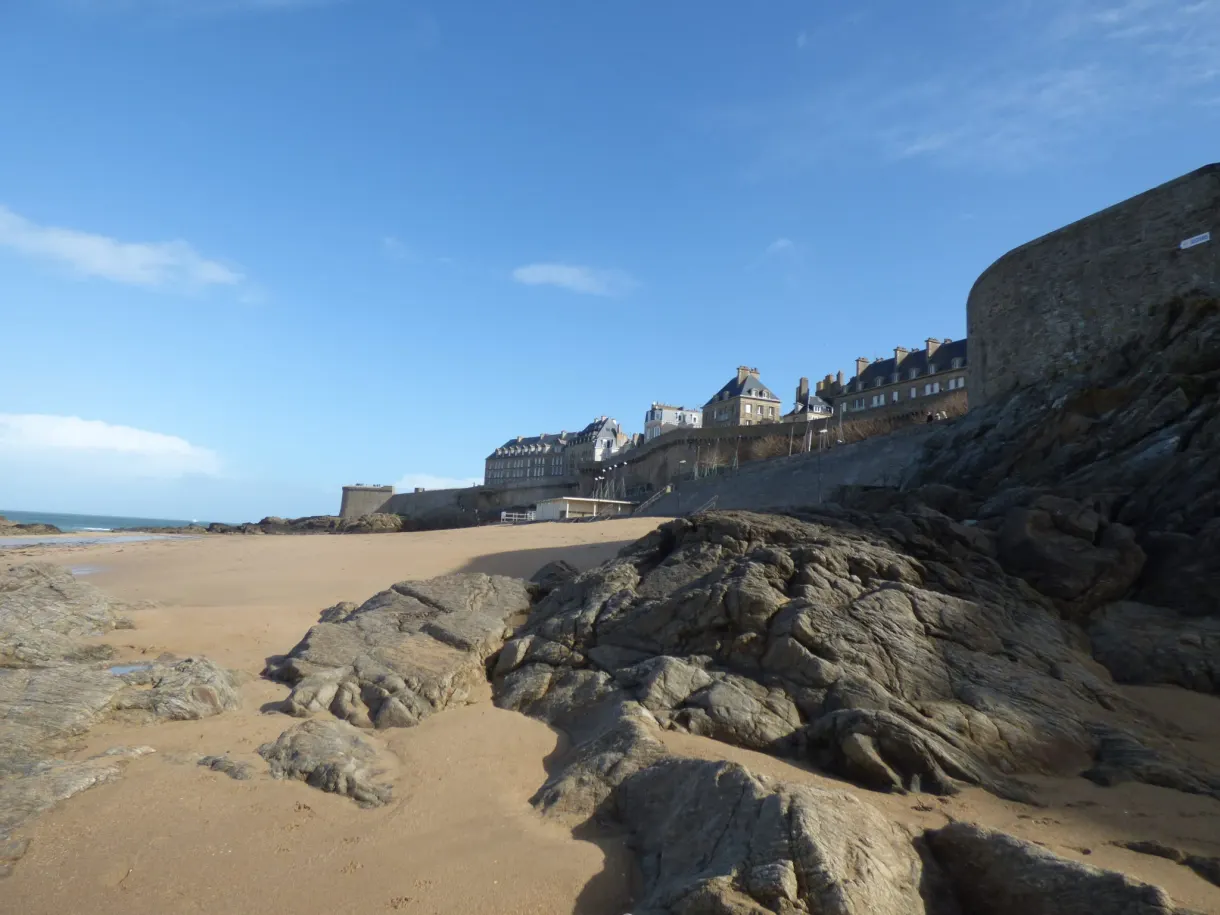 Rochers affleurant sur le sable devant les remparts