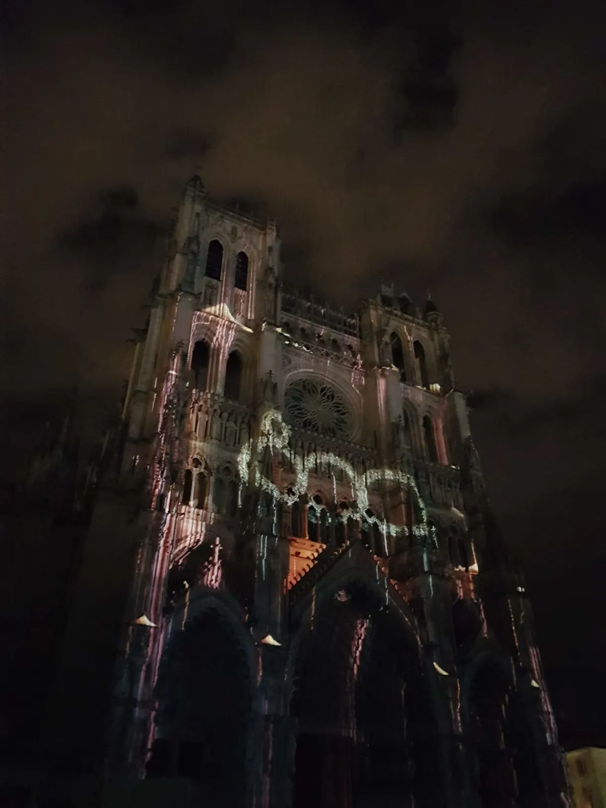 Gothic cathedral bathed in a night light projection