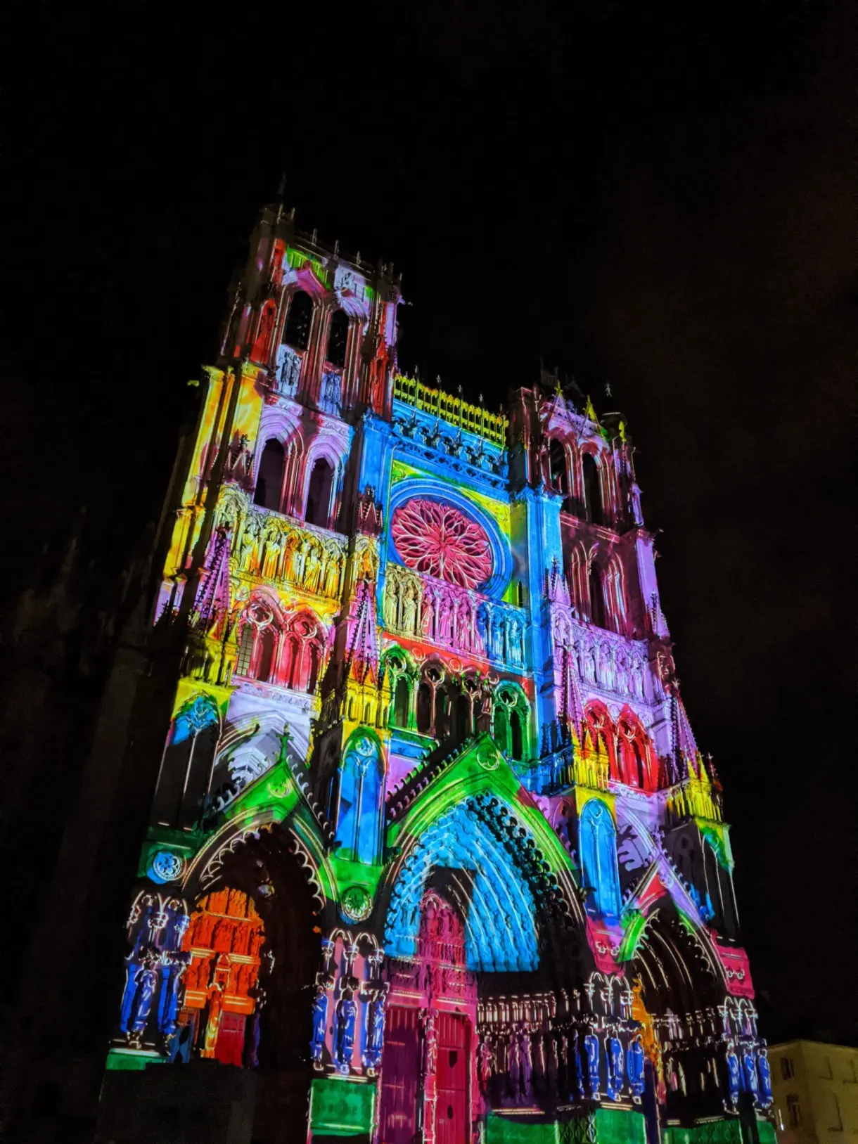 Facade of the cathedral painted in bright colours by the light