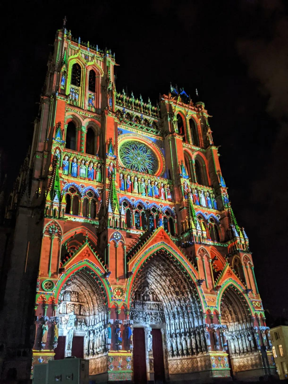Portals of the cathedral lit up in orange and blue