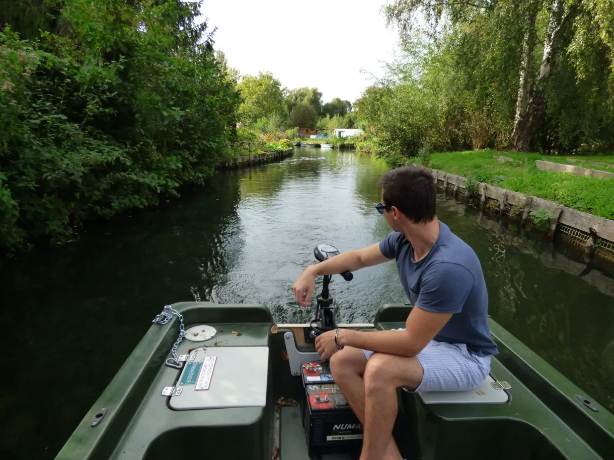 Boatman sitting at the back of the electric powered boat