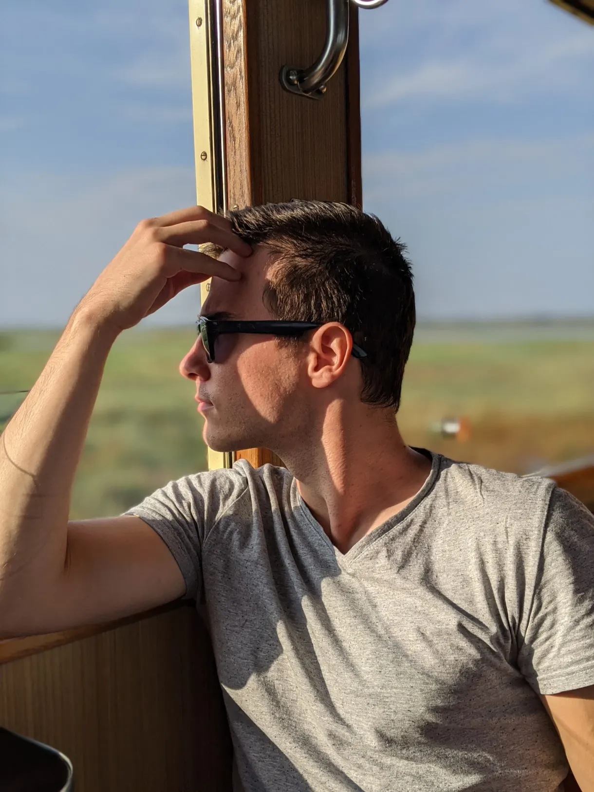 Traveller leaning on the carriage window, sunglasses on