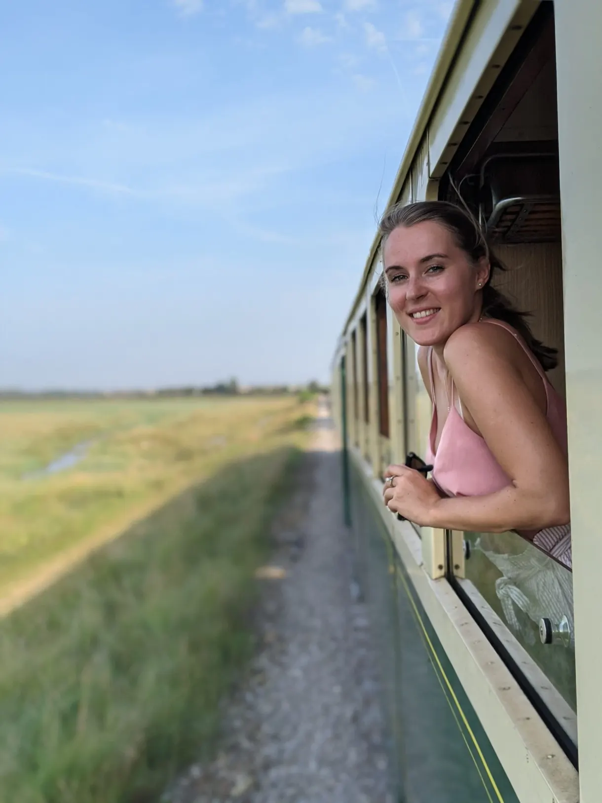 Traveller leaning out of the window of the steam train