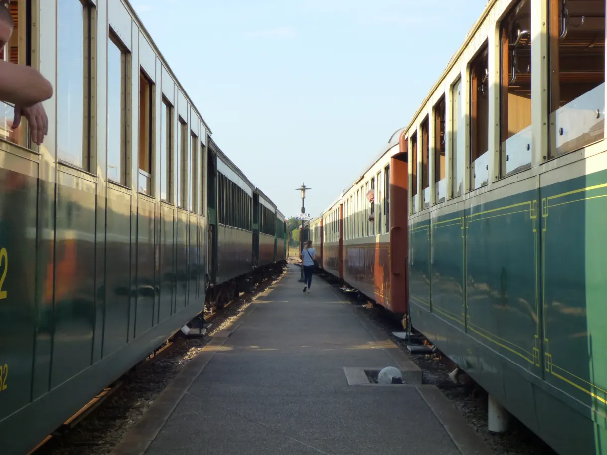 Platform squeezed between two rakes of green and cream vintage carriages