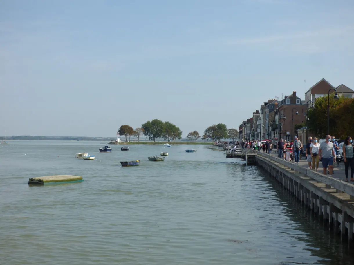 Busy quay running along the estuary and its boats at anchor
