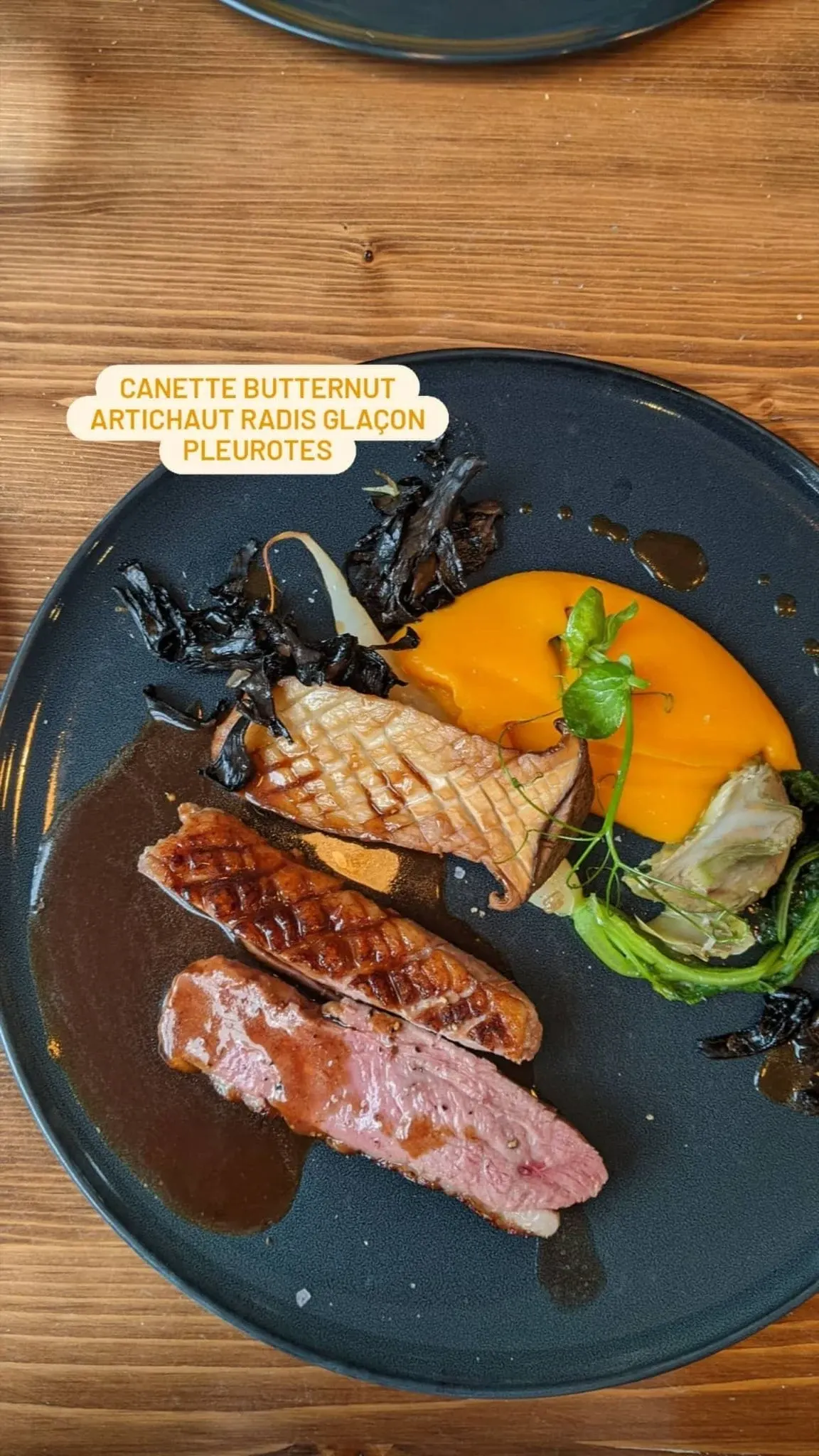 Roast duckling with butternut squash served on a blue plate