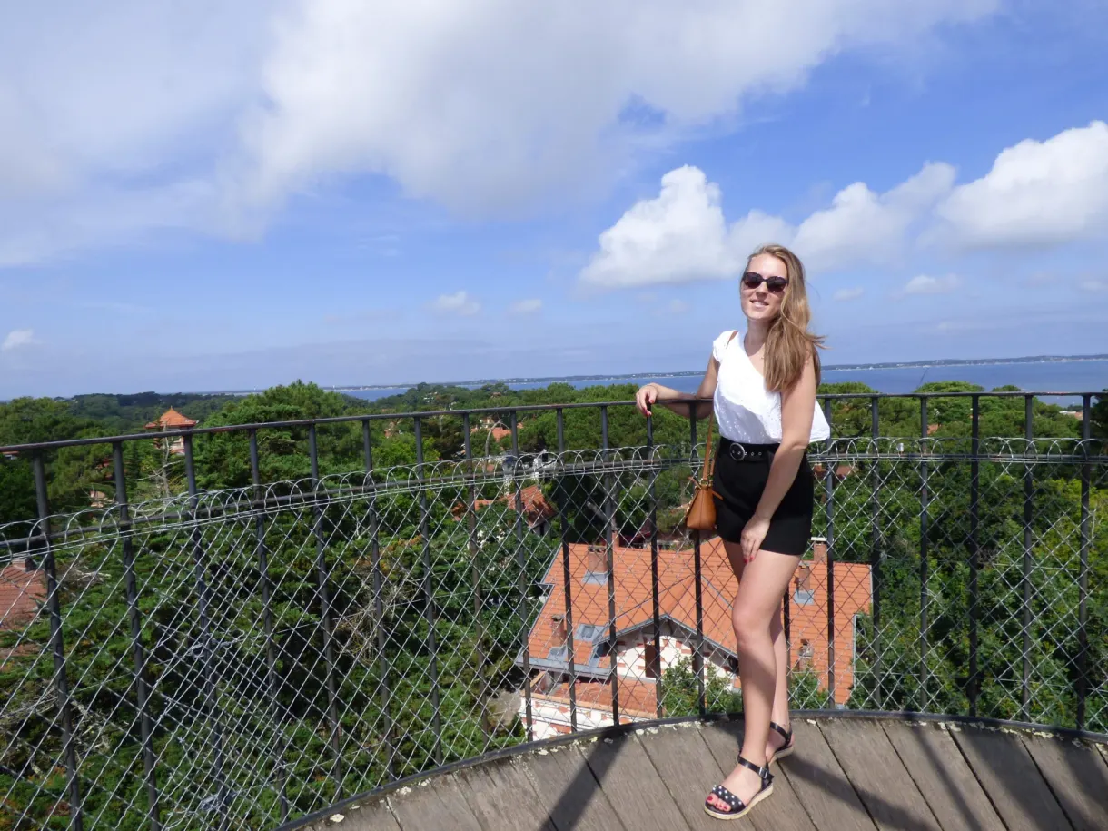 On the metal footbridge, rooftops and the basin in the background