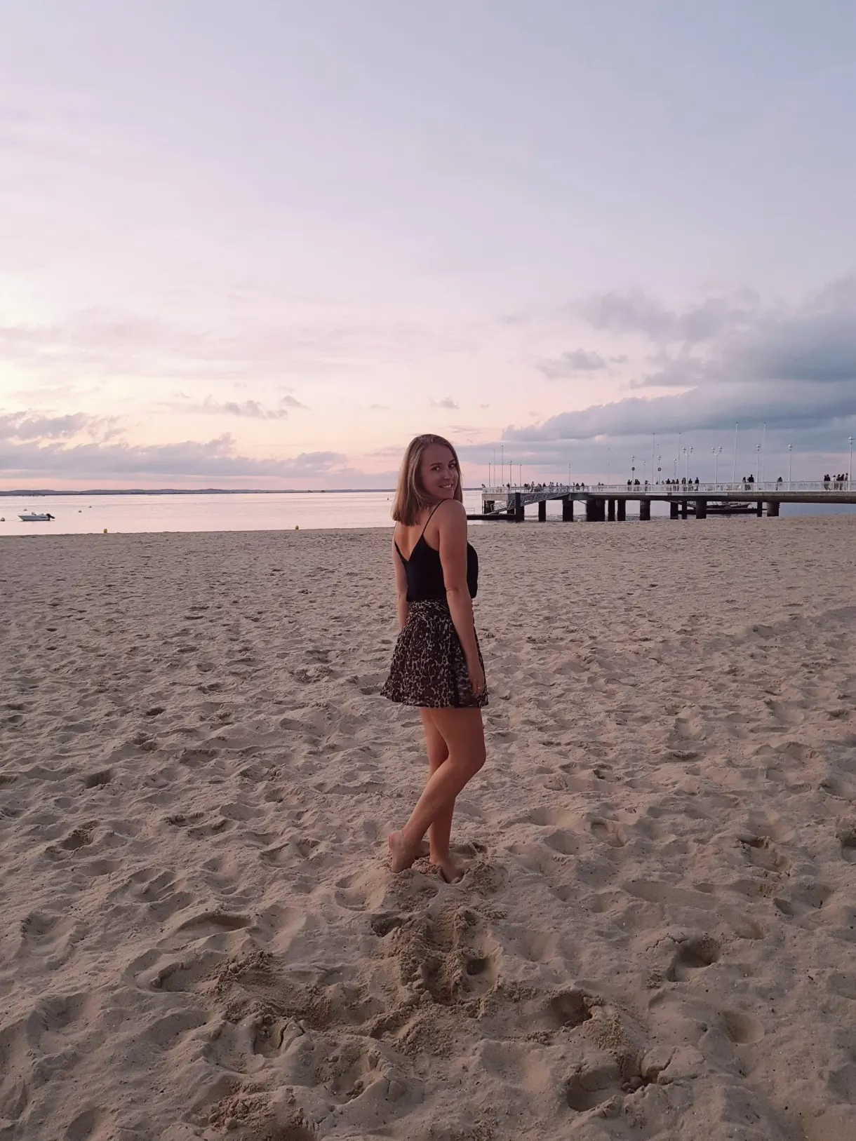 Beach at dusk, figure on the pink-tinged sand