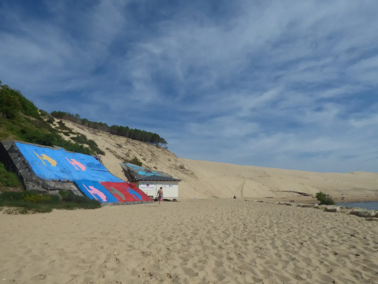 Hut covered with murals at the foot of the sand dune