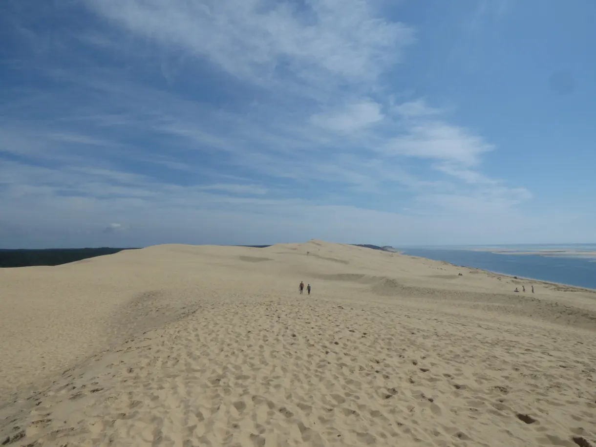 Crest of the dune walked by a few tiny figures