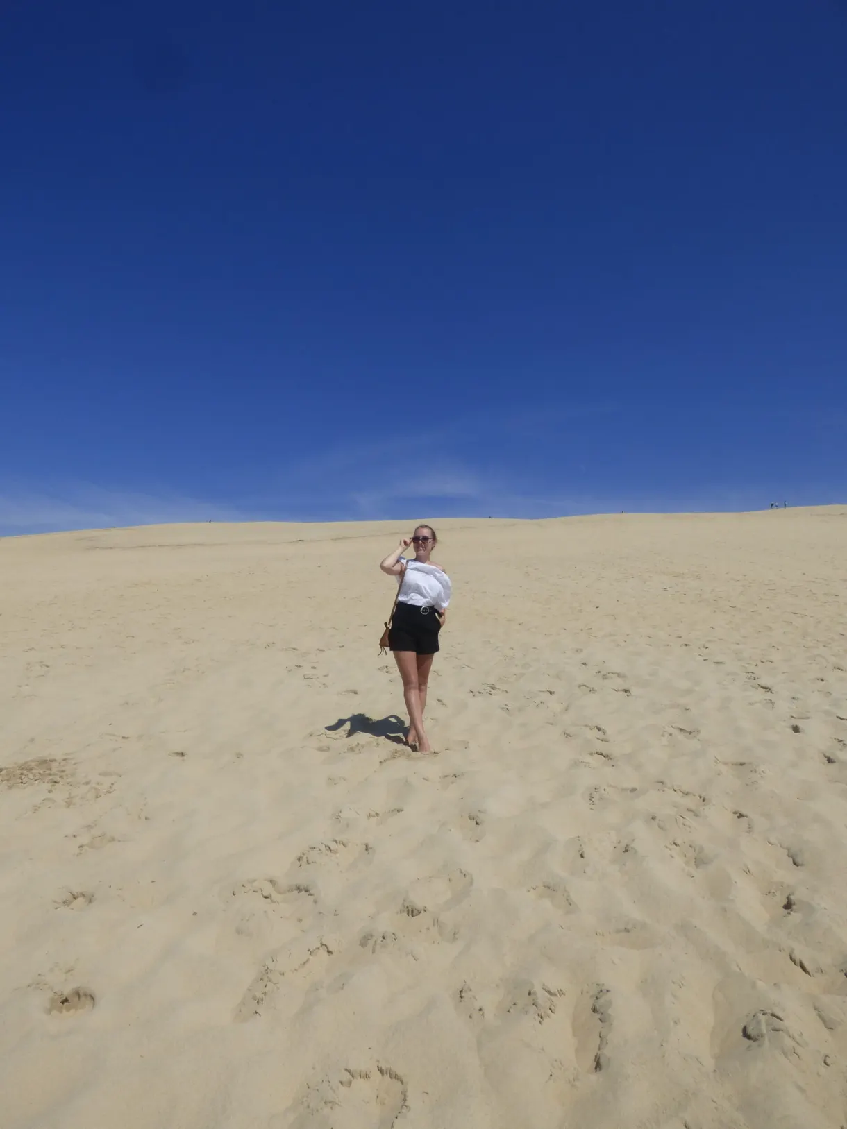 Lone figure on the huge slope of sand