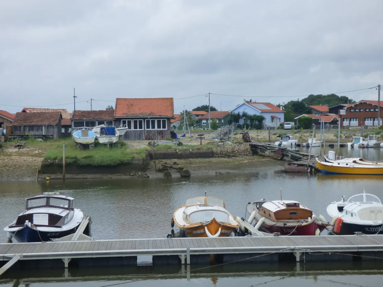 Oyster farmers' huts and boats moored in the harbour