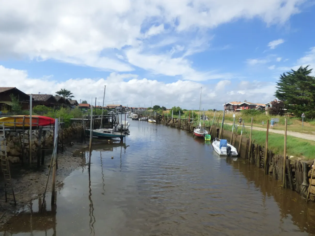 Channel lined with wooden pontoons and colourful pinasses