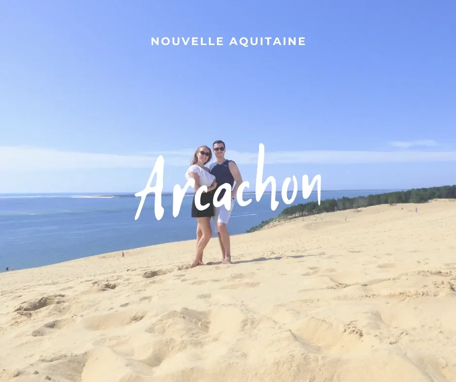 Couple posing on the sand dune facing the basin